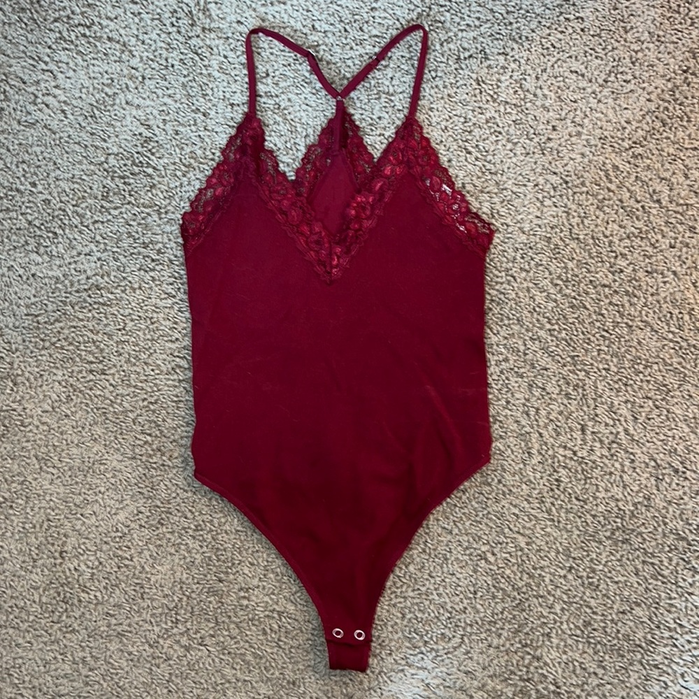 Maroon, lace-trimmed bodysuit.